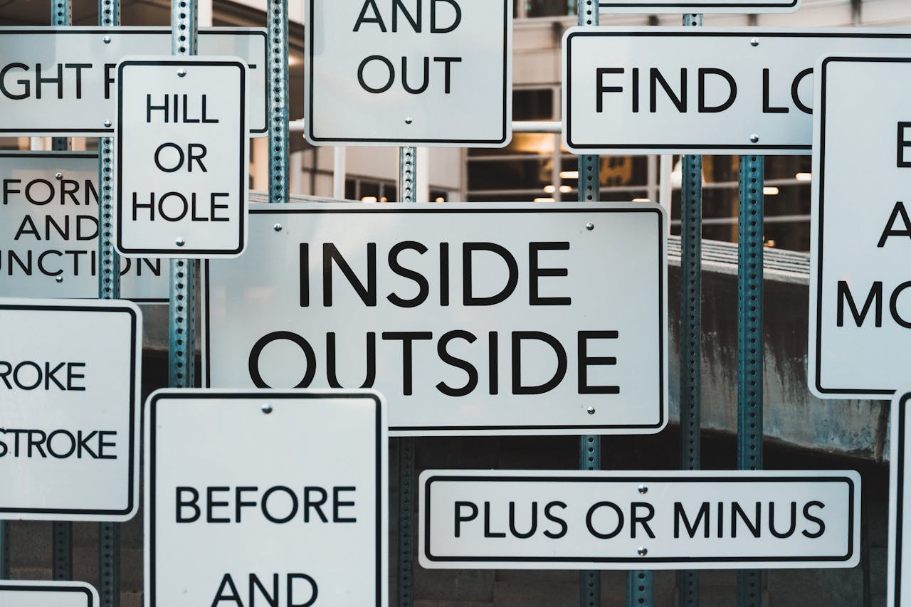 hero-img A creative display of street signs in Salt Lake City, showcasing contrasting messages and typography.